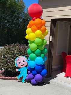 there is a giant balloon sculpture in the shape of a child's rainbow colored ballon