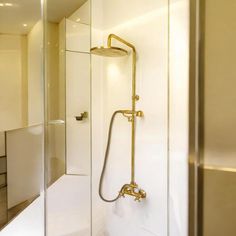 a bathroom with a shower head and glass walls