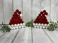 two red and white christmas trees made out of wine corks