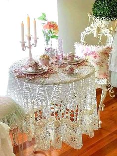 a white table topped with lots of plates and cups