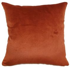 an orange pillow on a white background