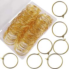 several pairs of gold colored metal hoops in a plastic container with the contents inside