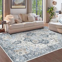 a living room filled with furniture and a large rug