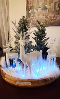 a wooden bowl with some fake trees and lights in it on top of a table