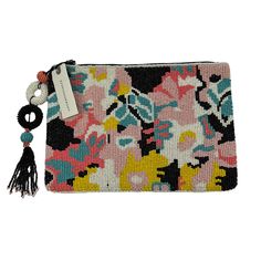 a small purse with flowers and tassels on the front, in multicolored fabric