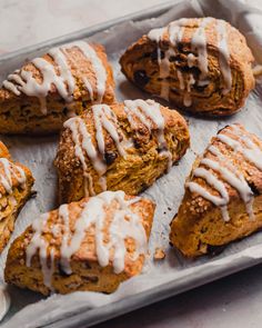 freshly baked pastries with white icing on a tray