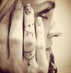 a woman holding her hand up to her face with the words new piercings on it