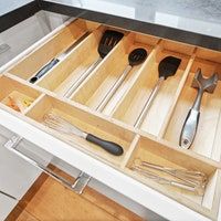 an open drawer with utensils in it