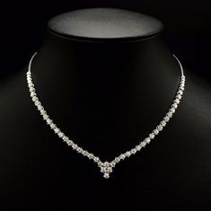 She'll never tire of wearing this classic and sophisticated diamond tennis necklace. Stunning in 18K solid white gold, this breathtaking line of shimmering round diamonds. So elegant, this 18.0-inch diamond necklace will take her breath away. Radiant with 3.08 cts. t.w. of diamonds and buffed to a brilliant luster, this glamorous keepsake secures with a box clasp. The setting design make the diamonds look much bigger than they are. When worn, the diamonds look like 1/5 carat each. Diamonds Detai Luxury Diamond White Diamond Necklace For Party, Luxury Diamond White Solitaire Necklace For Anniversary, Luxury Diamond White Diamond Necklace Hallmarked, Luxury White Gold Diamond Necklace With Round Stone, Luxury White Gold Necklace With Single Cut Diamonds, Luxury Diamond White Necklace For Celebration, Luxury Single Cut Diamond Bridal Necklace, Luxury Diamond Necklace With Diamond Eyes For Wedding, Luxury Dazzling Solitaire Necklace For Formal Occasions