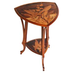 a wooden table with an elaborate design on it's top and bottom shelf in the shape of a bird