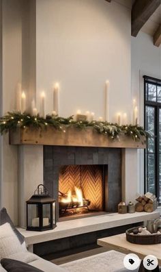 a living room filled with furniture and a fire place covered in christmas garlands next to a fireplace