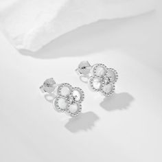 Our Clover Earrings are the perfect piece for every day or evening wear. KEY FEATURES Sterling Silver Size: 9.5x9.5mm High Quality Cubic Zirconia Stones White Classic Flower Earrings For Anniversary, Classic White Round Flower Earrings, Classic White Flower Earrings For Anniversary, Elegant White Pearl Earrings For Mother's Day, White Classic Flower Earrings For Pierced Ears, Classic White Flower Earrings For Pierced Ears, White Classic Flower Earrings, Classic White Flower Earrings, Elegant White Round Flower Earrings