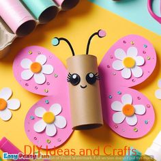 a paper roll butterfly craft with flowers on it