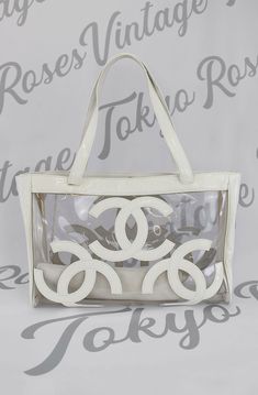 Chanel Transparent White Patent Logo Bag | Tokyo Roses Vintage Vintage White Shoulder Bag With Large Capacity, Elegant Clear Travel Bag, White Travel Bag With Clear Strap, White Shoulder Bag With Clear Strap, Luxury Clear Rectangular Bag, Luxury Clear Bags For Everyday Use, White Satchel Shoulder Bag With Clear Strap, Elegant White Bag With Clear Strap, Elegant White Bags With Clear Strap