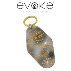 a glass keychain with gold lettering on it