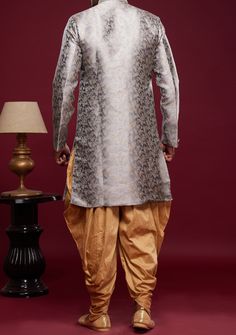 Ready-Made Sherwani With Peshawari Trouser. All Over Jacquard Brocade Style Fabric Top. Art Silk Peshawari Ready Made Trouser. Crafted in Chinese Collar Neck, and Full Sleeve. Satin Lining with Plain Work. High-Quality Matching Buttons. Please Note: The footwear shown in the picture is for presentation and photography purpose only. Color: There might be slight color variation due to lightings and flashes while photo shooting. The color may also vary because of different screen resolutions. Wash Festive Brocade Salwar Kameez In Traditional Drape, Transitional Season Bollywood Brocade Salwar Kameez, Transitional Bollywood Brocade Salwar Kameez, Semi-stitched Brocade Salwar Kameez For Festivals, Designer Brocade Salwar Kameez With Traditional Drape, Designer Brocade Salwar Kameez For Eid, Festive Brocade Salwar Kameez For Eid, Festive Bollywood Brocade Salwar Kameez, Designer Brocade Straight Kurta Sets