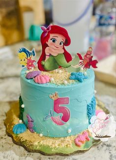 the little mermaid cake is decorated with fondant