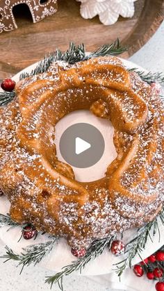 a christmas cake with powdered sugar and sprinkles is on a plate