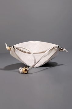 White leather pouch bag with quilting highlighted by gold plated metallic ball embellishments. - Aza Fashions Luxury Crossbody Shoulder Bag With Zipper Pouch, Leather Shoulder Bag With Pearl Handle, Luxury Pouch Bag With Pearl Handle, Luxury Pouch Shoulder Bag With Pearl Handle, Cream Pouch Bag With Gold-tone Hardware, Designer Pouch Bag With Gold-tone Hardware, Luxury Pouch Shoulder Bag With Gold-tone Hardware, White Leather-handled Pouch Satchel, Gold-tone Hardware Pouch Bag