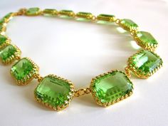 I am such a sucker for Peridot!  Bright and lively, unusual and striking- it is such a wonderful color.  Made even more wonderful because these are vintage Swarovski crystals.  They are heavily faceted and so sparkly.  The closest thing to real gems that you can find! I put these lovely stones into my favorite settings, custom made for me, with elaborate crown prongs and offset loops to prevent them from flipping.  They are open-backed settings, which is a great way to present these beautiful st Green Faceted Necklace For Party, Elegant Lime Green Faceted Jewelry, Elegant Lime Green Gemstone Necklace, Elegant Lime Green Necklace For Gift, Elegant Lime Green Necklace Gift, Handmade Lime Green Necklace Gift, Handmade Lime Green Necklace For Gift, Handmade Lime Green Necklaces For Gift, Regency Jewelry