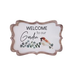 a sign that says welcome to our garden with a bird sitting on the tree branch