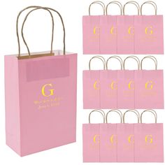 pink shopping bags with gold g on them