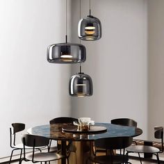 a dining room table with chairs and lights hanging from the ceiling