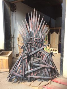 a large iron throne sitting on top of wooden pallets