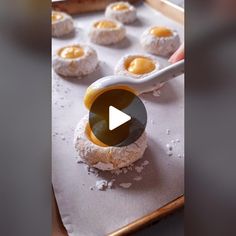 an image of doughnuts being made on a baking sheet with a video screen