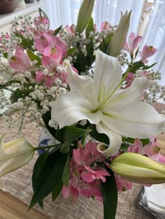 a vase filled with white and pink flowers