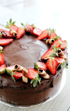 a chocolate cake with fresh strawberries on top