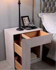 a night stand with two drawers and a lamp