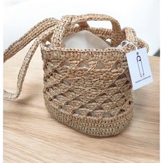 Welcome! 🌞 This Handwoven Straw Mini Bucket Bag is crochet to bring a warm, natural touch to your summer style. Made from hand-crocheted raffia and natural materials, this tote is perfect for beach trips or sunny city strolls. Whether you're using it for everyday outings or a special occasion, this unique bag will complement any look. It's also a wonderful choice if you're searching for a special gift to delight your loved ones. 👒✨ Beach Bucket Crochet Bag With Open Weave, Eco-friendly Crochet Bucket Bag With Adjustable Strap, Natural Fiber Crochet Shoulder Bag With Open Weave, Open Weave Crochet Shoulder Bag In Natural Fiber, Eco-friendly Crochet Bucket Bag For Beach Season, Eco-friendly Bucket Crochet Bag For Beach Season, Eco-friendly Jute Crochet Bucket Bag, Eco-friendly Crochet Bags In Natural Fiber, Eco-friendly Crochet Bags Made Of Natural Fiber