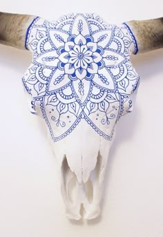 an animal's skull is decorated with blue and white designs