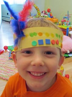 a young boy wearing a colorful headband and smiling