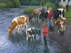 a group of people standing in the water with cows