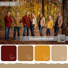 a group of people standing next to each other in front of trees with fall colors