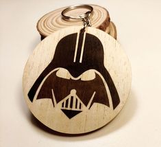 a wooden keychain with a star wars darth vader face on it