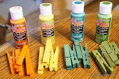 several crafting supplies are arranged on a wooden table, including clothes pins and glue