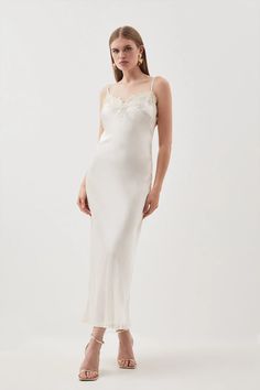 Imbued with lingerie codes, this elegant midi dress is crafted from languid satin that flows over the silhouette with an ethereal essence. This piece is trimmed with a lace border and lands at a slip skirt, calling for the tactile contrast of soaring metallic stilettos.Slim shoulder strapsLace trimPlunge neckMidi length Bride Jumpsuit, Ethereal Essence, Plus Size Workwear, Elegant Midi Dress, Lace Weave, Elegant Midi Dresses, Midaxi Dress, Slip Skirt, Khaki Dress