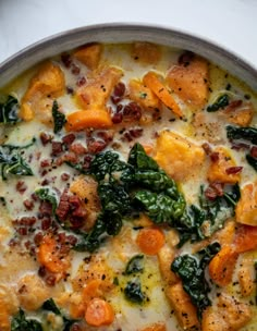 a pan filled with cheese and vegetables on top of a table