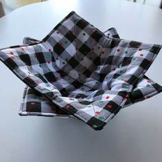 a black and white checkered bow tie on top of a round table with polka dots