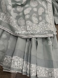 Gray chikankari saree has a subtle border and paisley motifs on the palla, finished with crocheted lace. *Petticoat included! *Hand embroidered *Includes an embroidered blouse piece *Fall attached Cotton Sharara With Chikankari Embroidery, Semi-stitched Cotton Traditional Wear With Lace Work, Semi-stitched Cotton Dupatta With Lace Work, Semi-stitched Traditional Wear With Lace Work In Cotton, Festive Cotton Sharara With Lace Work, Cotton Sharara With Intricate Embroidery, Festive Cotton Dupatta With Lace Work, Anarkali Cotton Saree With Chikankari Embroidery, Fitted Cotton Dupatta With Lace Work