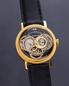 Our exclusive Raketa Skeleton customized handcrafted watch is a stunning display of  craftsmanship and attention to detail. It features an open skeleton design, revealing the intricate workings of the movement underneath. The exposed mechanism is meticulously finished with golden gears and components, creating a beautiful contrast against the steel case and surrounding elements. This exquisite vintage skeleton wristwatch is a remarkable showcase of intricate craftsmanship and timeless design. Th Gold Automatic Watches As Gift, Gold Automatic Watch For Gift, Gold Automatic Watches As A Gift, Gold Automatic Watch For A Gift, Gold Automatic Watches For Gift, Black Watches With Rotating Bezel For Gifts, Steampunk Watch With Skeleton Dial, Steampunk Gold Watch As Gift, Gold Steampunk Watch With Skeleton Dial