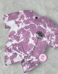 Acid wash bleached soft-style tee. Material is 65% polyester and 35% ring spun cotton. The image used is a screen print transfer. The sizing is UNISEX so please refer to size chart for measurements. Spring Acid Wash T-shirt With Sublimation Print, Custom Print Tie Dye Cotton T-shirt, Casual Tie Dye Tops With Floral Print, Faded Soft-washed T-shirt For Spring, Spring Bleached Relaxed Fit T-shirt, Relaxed Fit Bleached T-shirt For Spring, Bleached Relaxed Fit T-shirt For Spring, Cute Tie Dye T-shirt For Spring, Cute Tie-dye T-shirt For Spring