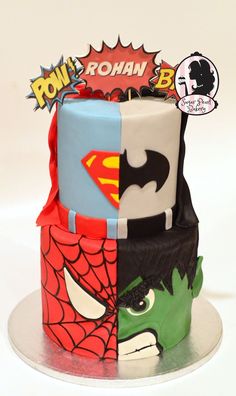 a three tiered cake decorated to look like superheros