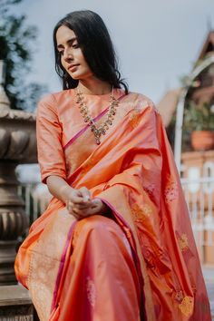 "A\u00a0delicate colour and a heritage paisley motif enveloped with delicate meenakari accents! Exquisite, individually woven kadhua bootas on a beautiful\u00a0resplendent\u00a0bed of silk\u00a0- this saree is a\u00a0charming piece of handloom heritage, with love from Banaras.\n\u00a0\n\n\n\n\n Color\u00a0-\u00a0A\u00a0beautiful\u00a0shot colour of Orange and Light Pink\n\n Technique\u00a0- An enduring Kadwa weave and fine Meenakari technique. The elaborate and laborious Kadwa (Kadhua) technique involves hand-weaving each motif separately. It takes longer on the handloom, but makes a more robust pattern, which stands out on the fabric.\n\n Fabric\u00a0- Soft as butter, pure Katan silk\n\n Speciality\u00a0- Intricate paisley kadhua bootas set against an artistic zari border and aanchal. A t Paisley Motif, Orange Saree, Katan Silk, Old Money Style, Designer Dresses Indian, Handloom Saree, Light Orange, Ethnic Wear, Fabric Color