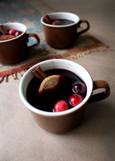 two mugs filled with liquid sitting on top of a table