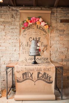 a cake on top of a table with a sign behind it