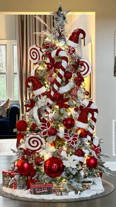 a christmas tree decorated with candy canes and candies in red, white and silver